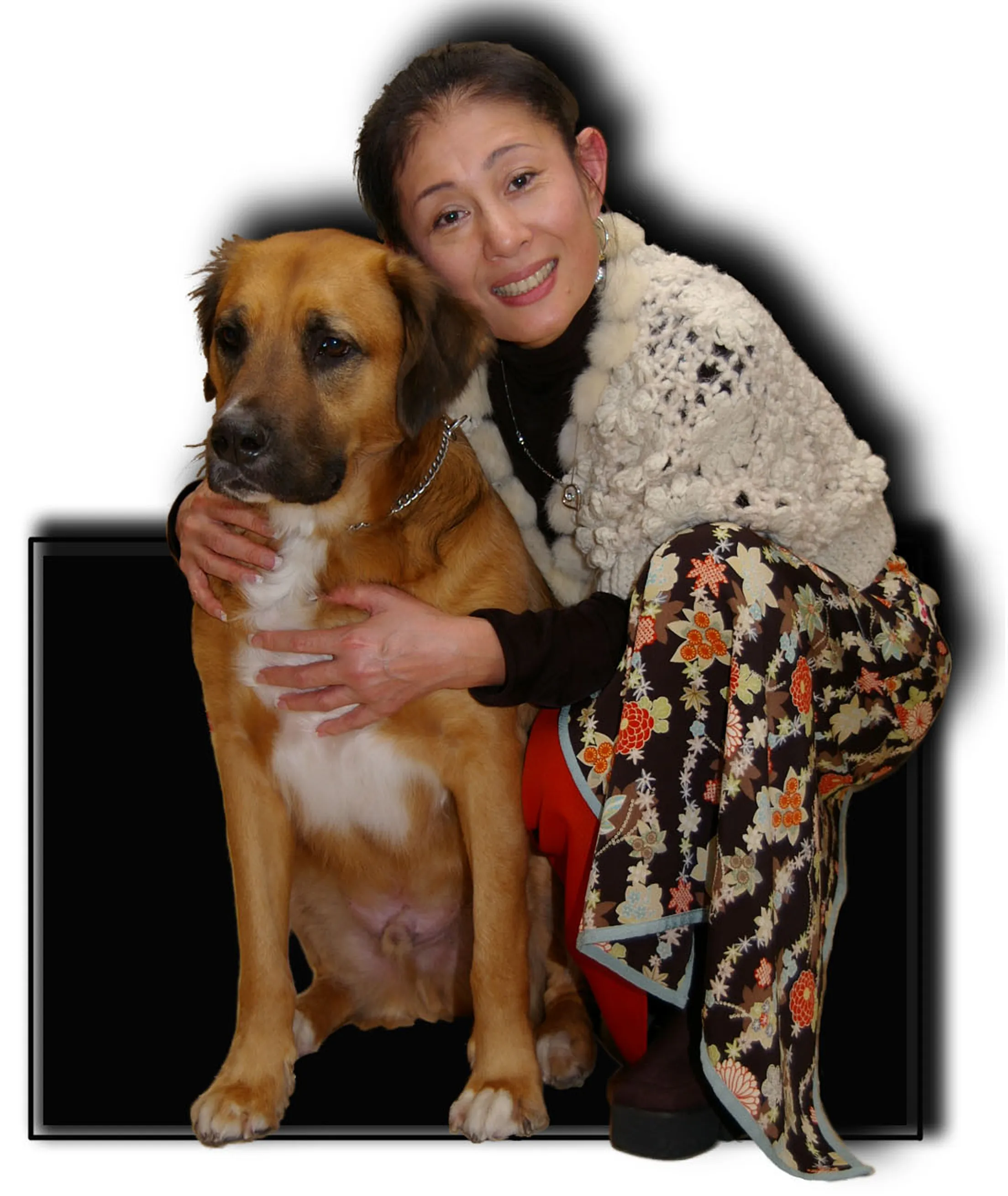 Woman hugging a large dog while sitting.